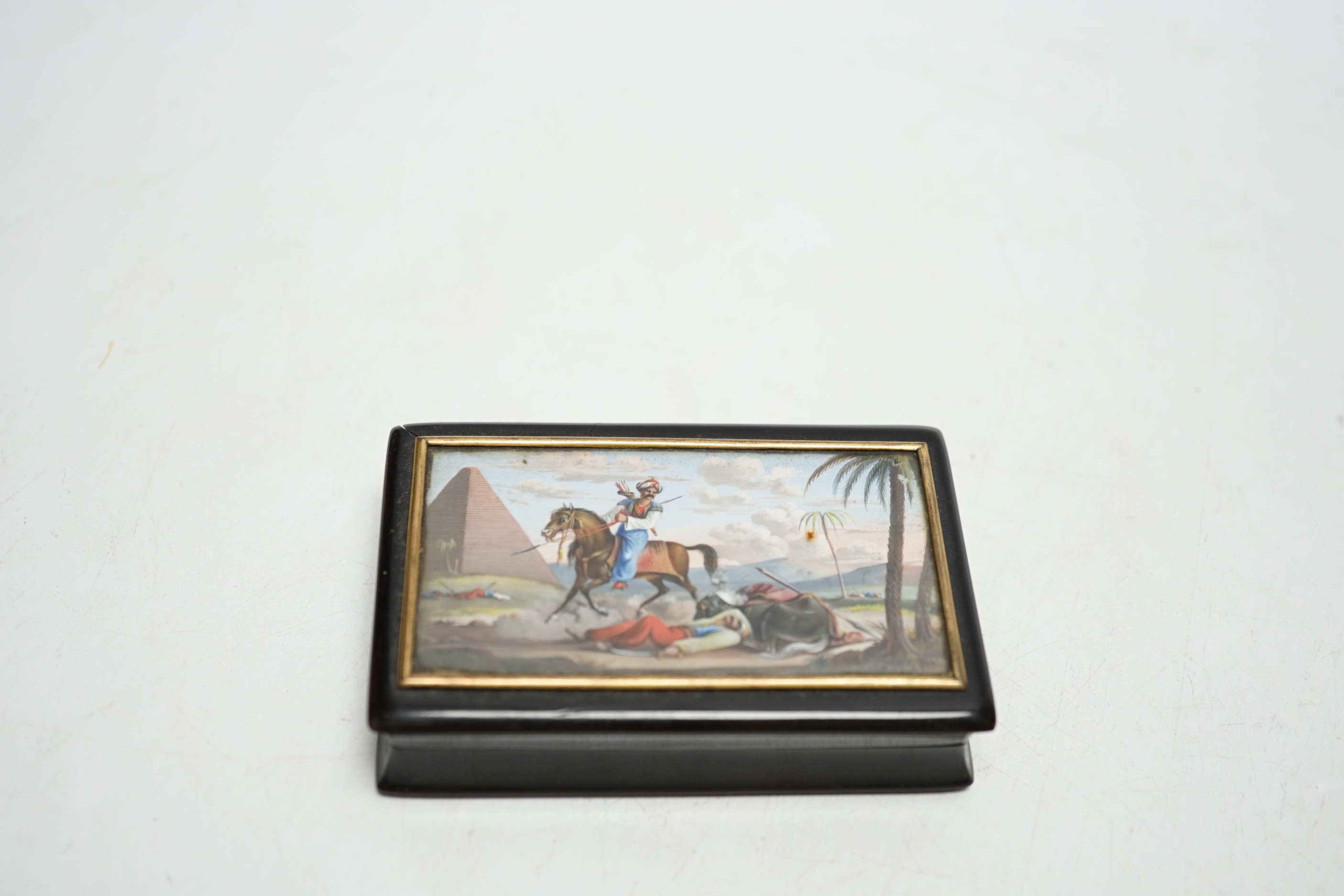 A 19th century tortoiseshell table snuff box, the hinged lid painted with an Egyptian battle scene, 9cm wide x 5.5cm deep